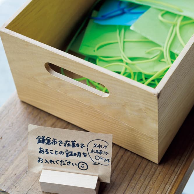 まずは名刺をケースに。 　鎌倉勤務であることを示す名刺を首にかけて入店。