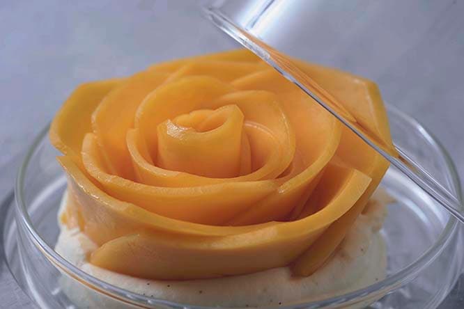 一度は食べてみたいタルトケーキは、サブレクッキーをベースにカスタードを重ね、ばらの花びらのようにスライスした〈白銀の太陽〉ブランドの北海道産マンゴーで作られている。この構造は庄司が手がけるすべてのケーキに共通している。