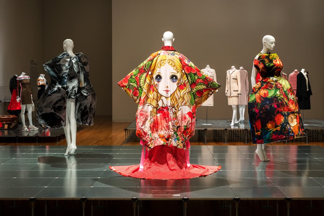ファッションを巡る13の問いかけとともに構成される展示。アートとファッションの関係性を問う「06.教養は身につけなければならない？」では、コム デ ギャルソンの作品を中心に展示を構成。中央に写るのは高橋真琴のイラストを大胆にフィーチャーした2018年春夏のコレクション。