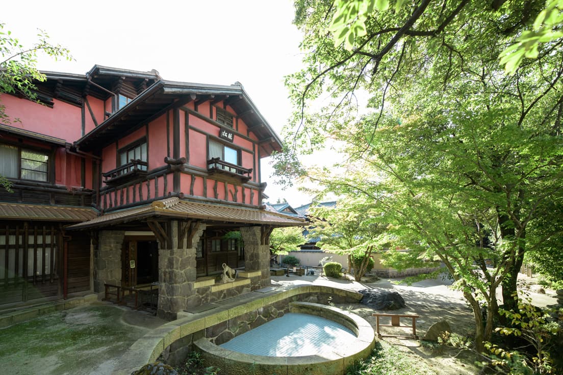 〈揚輝荘〉の迎賓館の一つ「聴松閣」。ベンガラ色の外壁は、戦時中に塗り替えられていたのを、修復整備で元に戻した。車寄せ天井は、漆喰塗りで角を見せないように仕上げている。