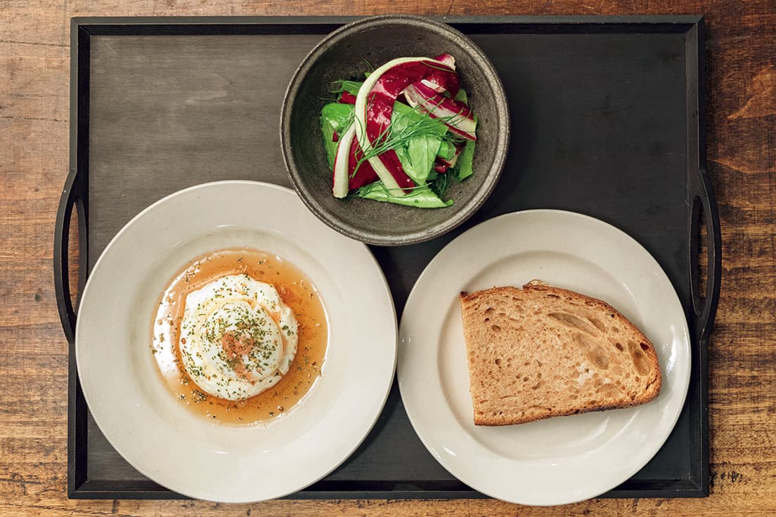 ターキッシュエッグ、サラダ、パン（LUNCH）
平飼い卵は半熟で、ニンニク入りのヨーグルトと焦がしバターのソースが〈パン屋塩見〉のカンパーニュによく合う。2,500円（ドリンク付）。
