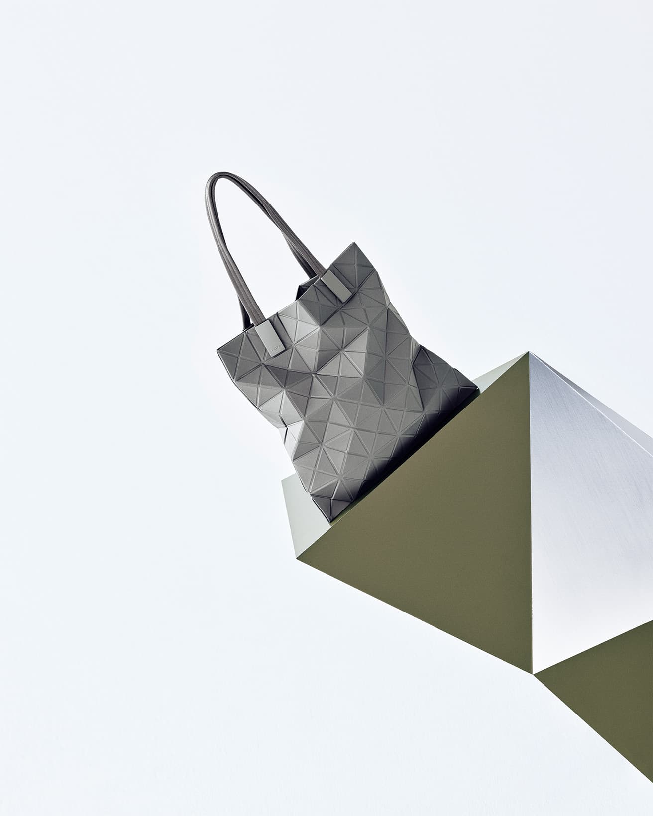 《Tote Bag》「常に新しいものを考え続ける」というブランドの哲学通り、〈BAO BAO〉を象徴する三角モチーフを、より日常になじむデザインに昇華させた。素材から金具まで6年かけて開発。マチなしトートバッグには13インチPCが入る。W34 ×H34㎝ グレー 55,000円。