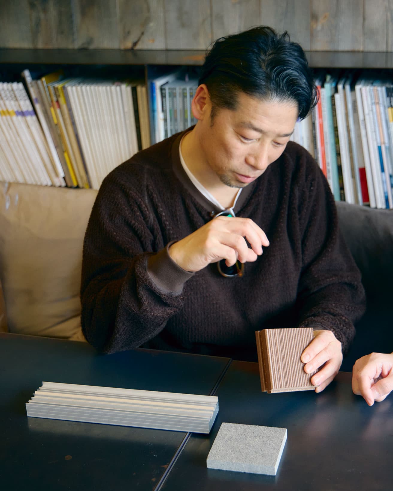 谷尻さんが手にするのは《revia（レビア）》。廃プラスチックと廃木材を原料に、押出成型した素材で幅広い活用が期待できる。