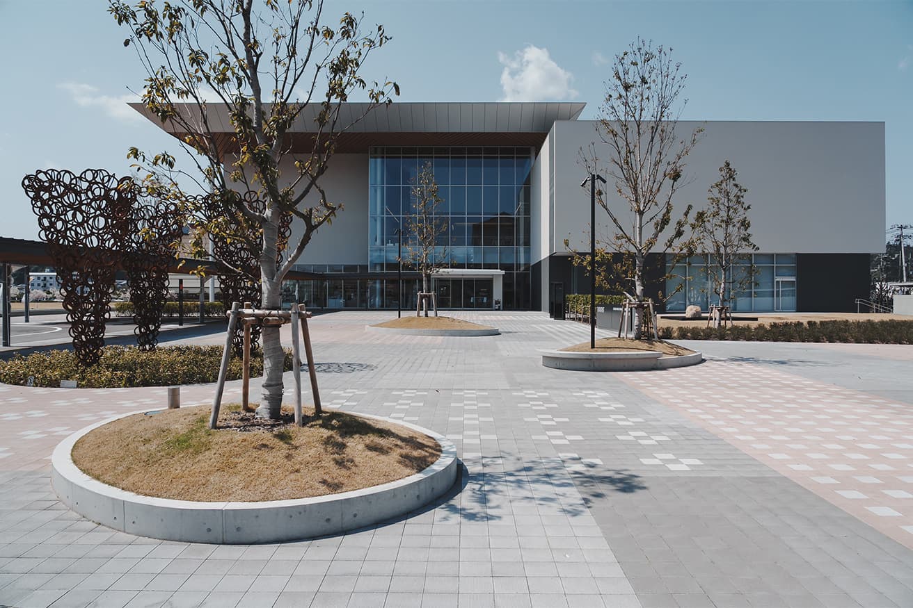 〈鳥取県立美術館〉エントランス。左側に青木野枝の屋外作品《しきだい》（2025年、常設作品）がある。