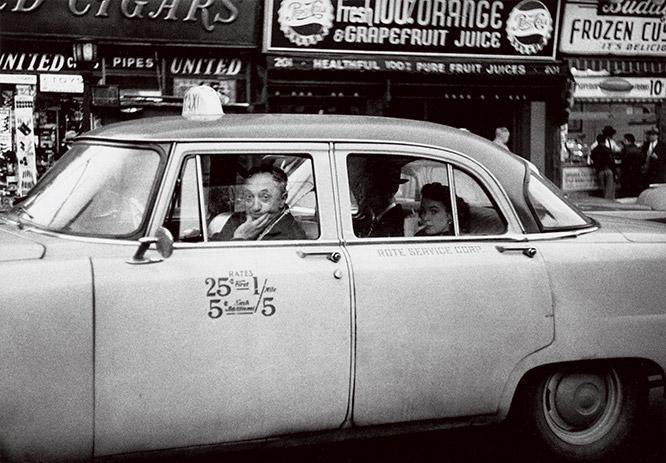 Taxicab driver at the wheel with two passengers, N.Y.C. 1956