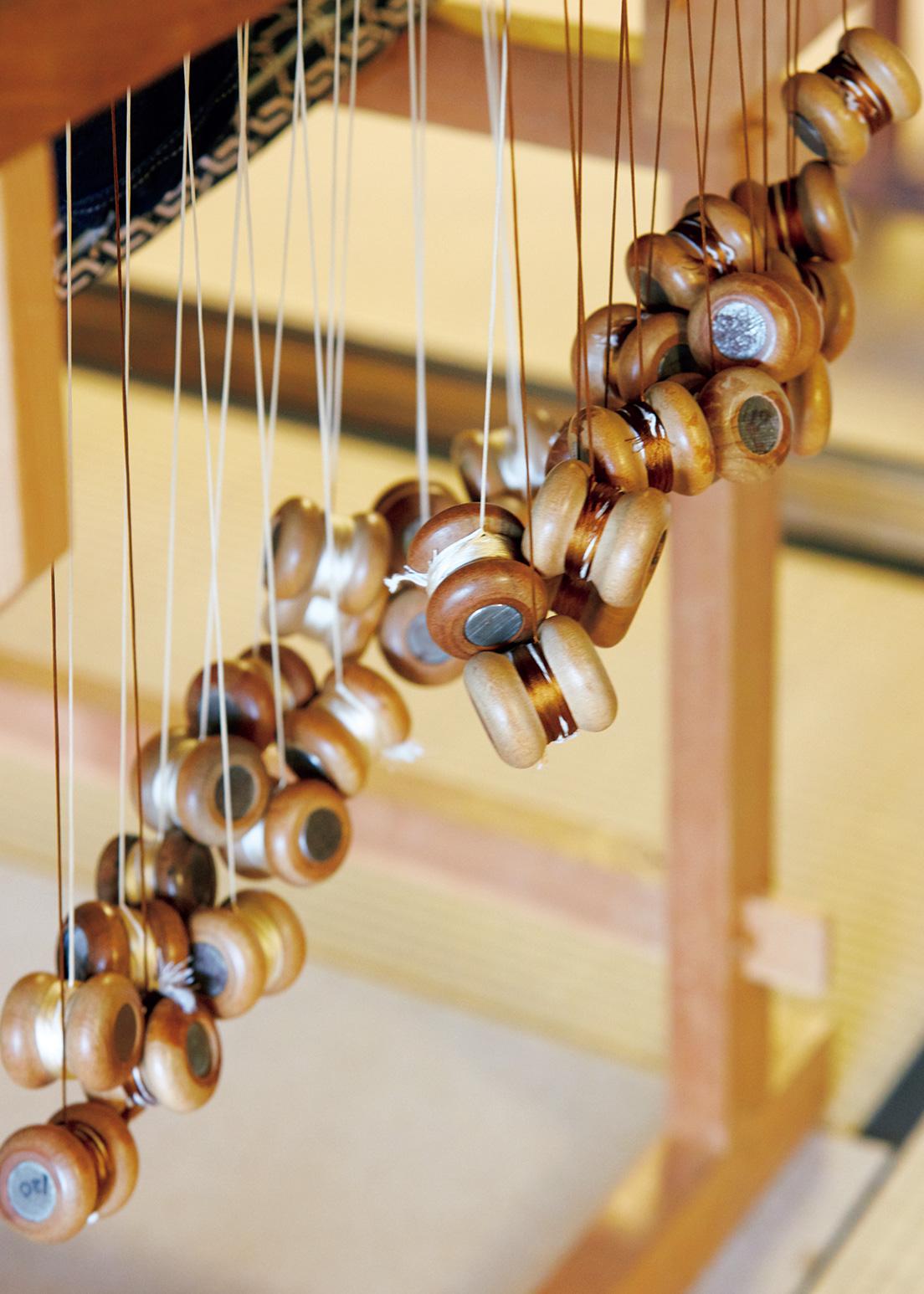 伝統的な組台で組む時に使うのが、糸端を巻きつける木製の「玉」。