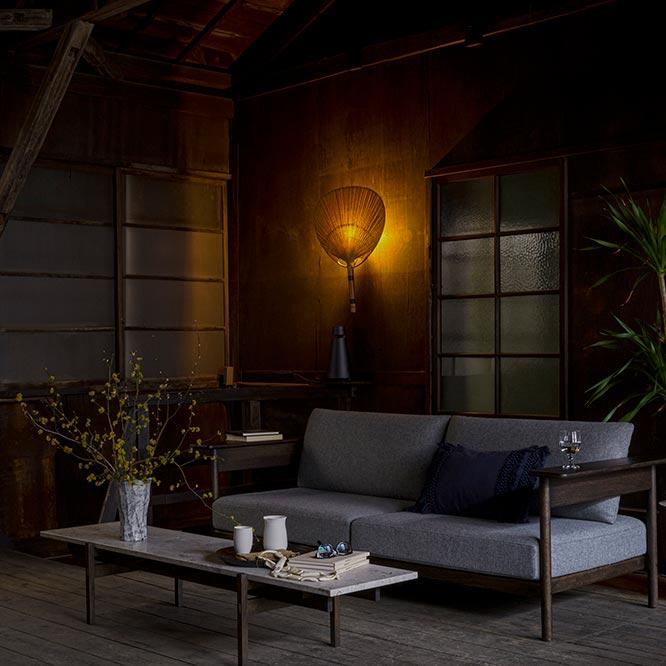 〈クヴァドラ〉のファブリック「ハリンダル65」を採用した〈カリモクケーススタディ〉のソファ、大理石の天板が特徴的なコーヒーテーブル。