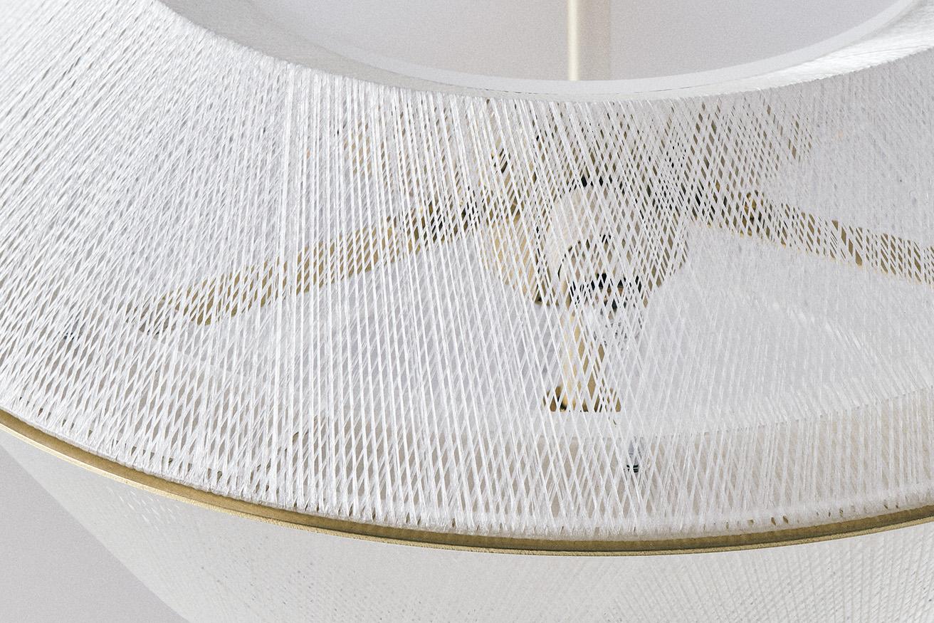 古代から絹織物で栄えた群馬・桐生の技術で成型されたシェード。樹脂で強化されたグラスファイバーが光を散乱する。